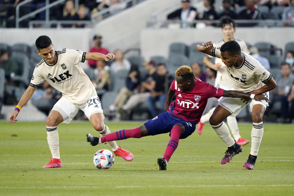 Dallas FC forward Jader Obrian, center, is defended by Los Angeles FC midfielder Eduard Atuesta, left, and defender Eddie Segura during the first half of an MLS soccer match Wednesday, June 23, 2021, in Los Angeles. (AP Photo/Marcio Jose Sanchez)