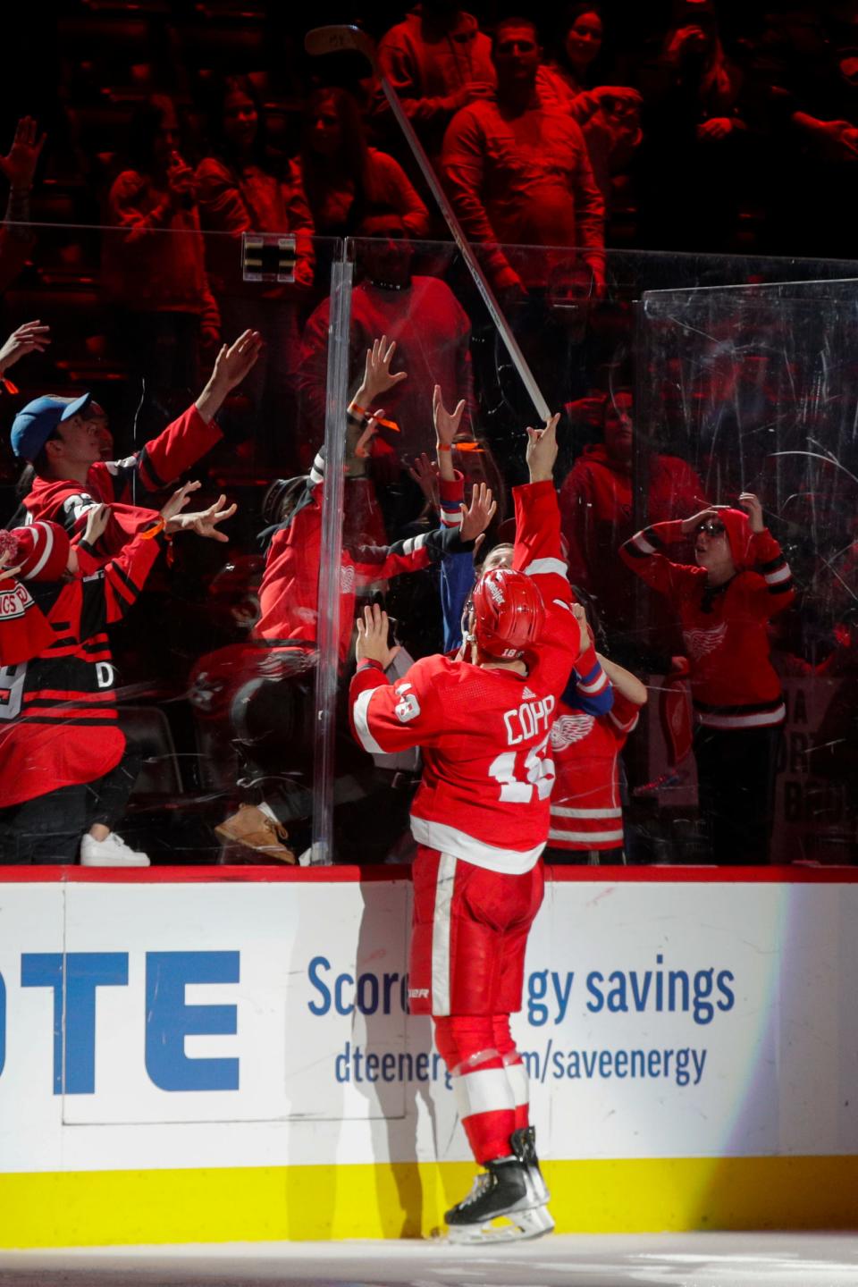 Red Wings center Andrew Copp tosses his stick into the crowd at the conclusion of the Wings' 4-1 win over the Rangers on Thursday, Feb. 23, 2023, at Little Caesars Arena.