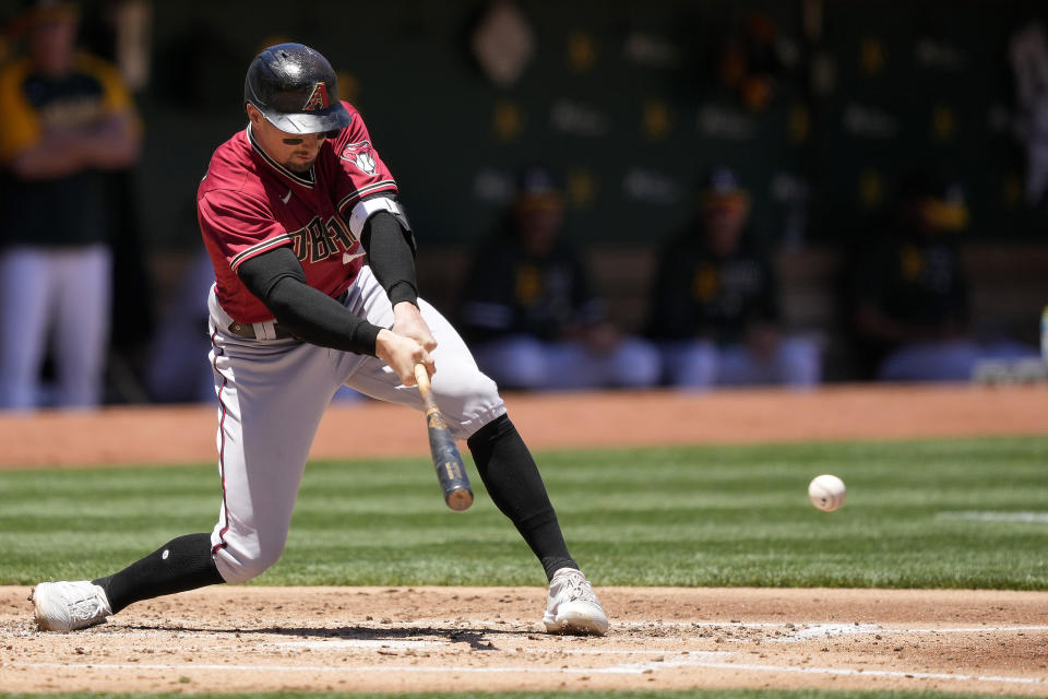 Arizona Diamondbacks' Tim Locastro hits a single against the Oakland Athletics during the second inning of a baseball game Wednesday, June 9, 2021, in Oakland, Calif. (AP Photo/Tony Avelar)