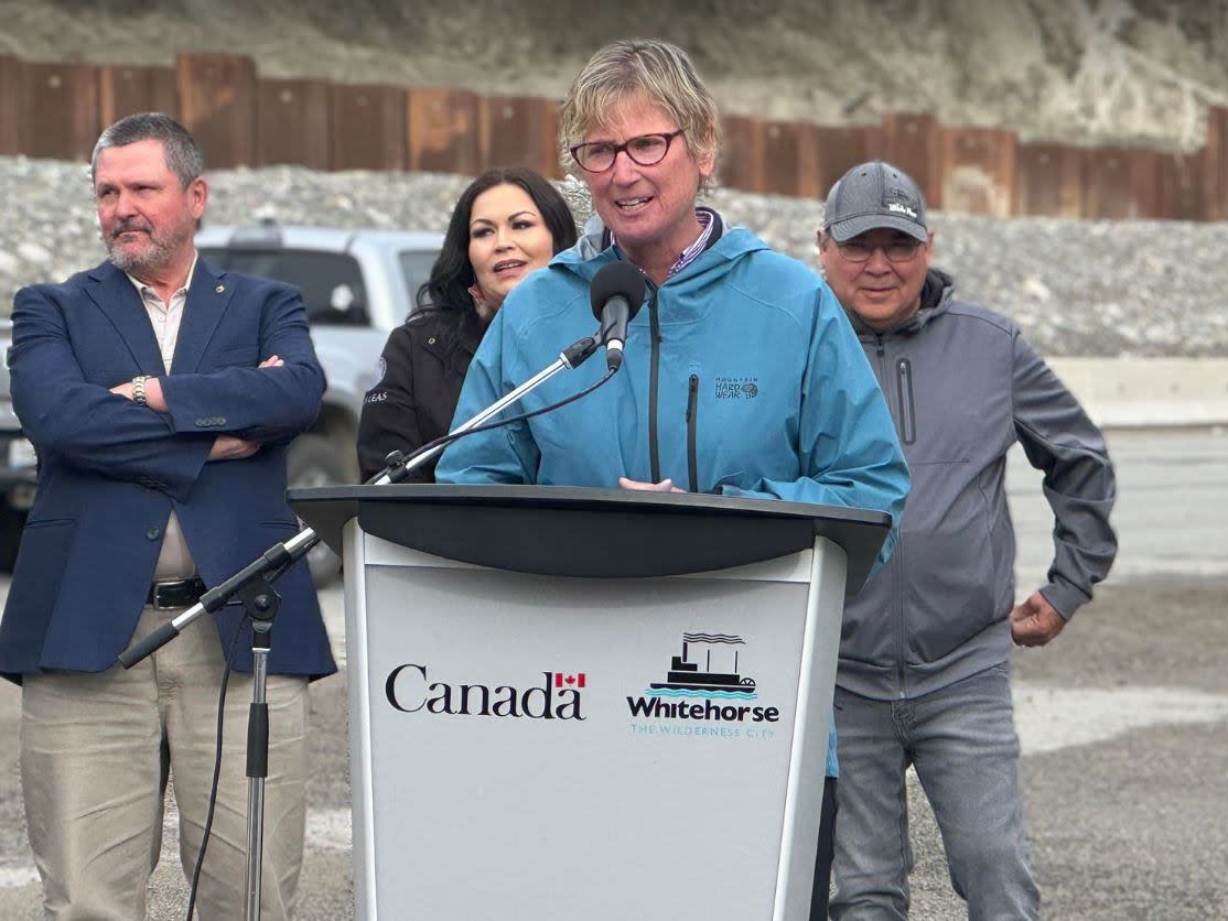 Whitehorse Mayor Laura Cabott speaks at a news conference on Monday to announce $45 million in federal funding for work on part of the city's escarpment alongside Robert Service Way. The work will see a realignment of the roadway to reduce the risk of landslides and road closures. (Maria Tobin/CBC - image credit)