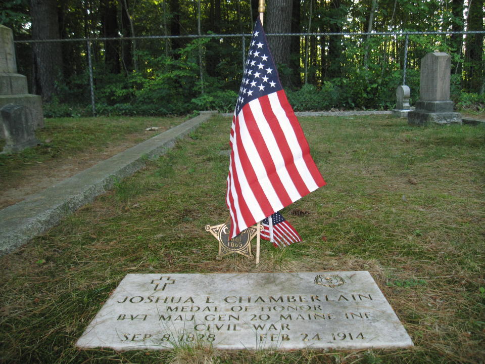 This July 12, 2012 photo shows the plaque at the gravesite in Pine Grove Cemetery in Brunswick, Maine, where Joshua Chamberlain is buried. During the Civil War, Chamberlain led Union forces during the Little Round Top victory at the Battle of Gettysburg and later accepted the Confederacy surrender at Appomattox in Virginia. (AP Photo/Beth Harpaz)