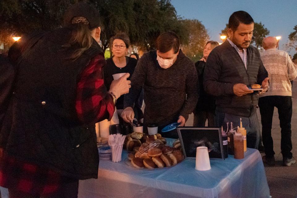 A crowd gathers to eat doughnuts and drink hot cocoa to celebrate the first night of Chanukah on Nov. 28, 2021, in Phoenix.