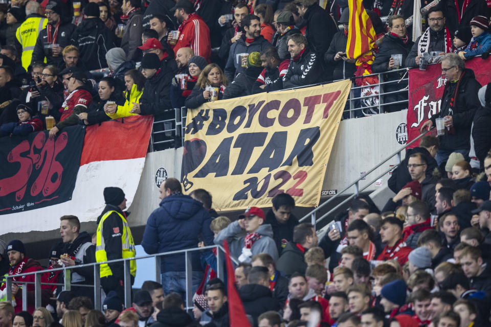 A placard with the inscription "Boycott Qatar 2022" can be seen in the SC Freiburg fan block before the Bundesliga soccer match between Freiburg and FC Union Berlin at Europa-Park Stadion in Freiburg im Breisgau, Germany, Sunday, Nov. 13, 2022. . (Tom Weller/dpa via AP)