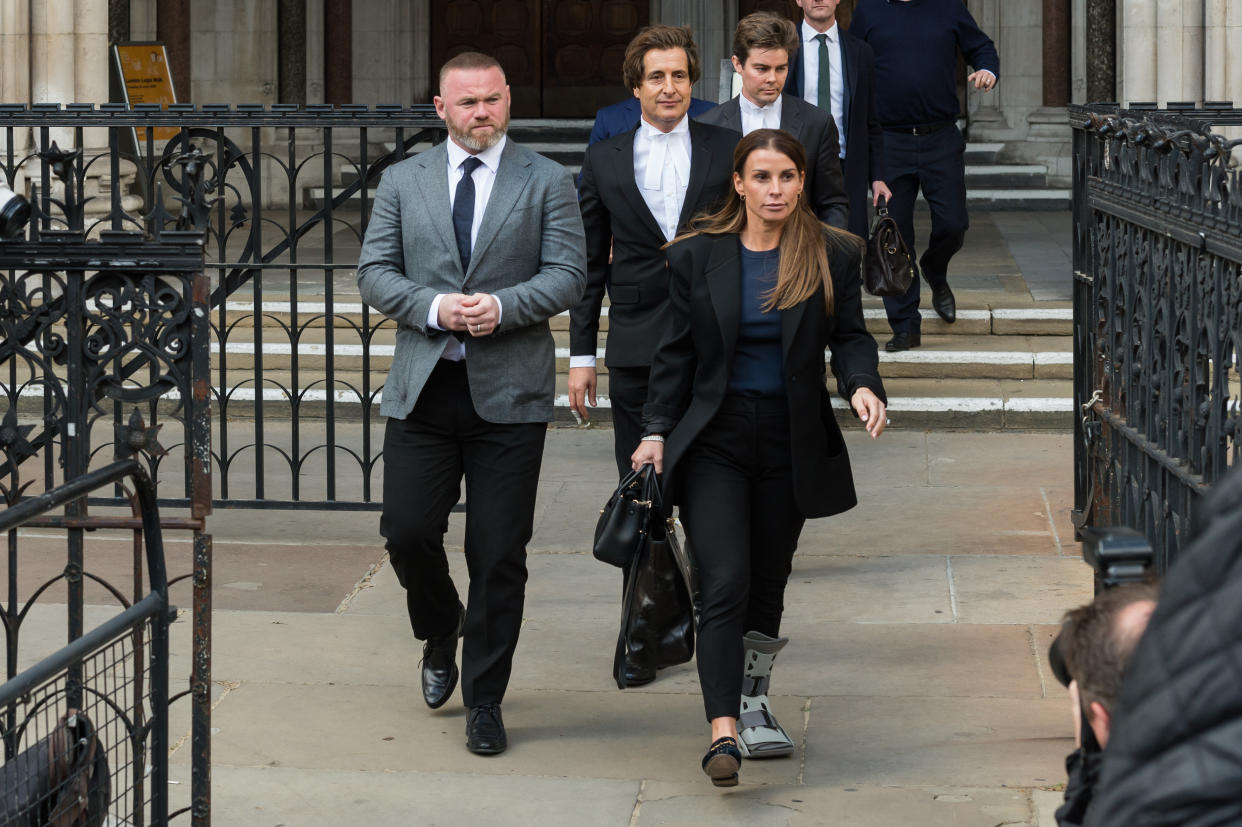 Former England footballer Wayne Rooney (L) supported his wife at the Royal Courts of Justice on the first day of the hearing (Getty Images)