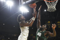 Michigan guard Kobe Bufkin, left, drives to the basket against Ohio forward Dwight Wilson III in overtime of an NCAA college basketball game, Sunday, Nov. 20, 2022, in Ann Arbor, Mich. (AP Photo/Jose Juarez)