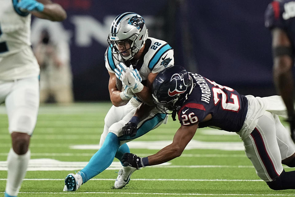 Carolina Panthers running back Christian McCaffrey (22) catches a pass as Houston Texans cornerback Vernon Hargreaves III (26) tackles him during the first half of an NFL football game Thursday, Sept. 23, 2021, in Houston. (AP Photo/Eric Christian Smith)