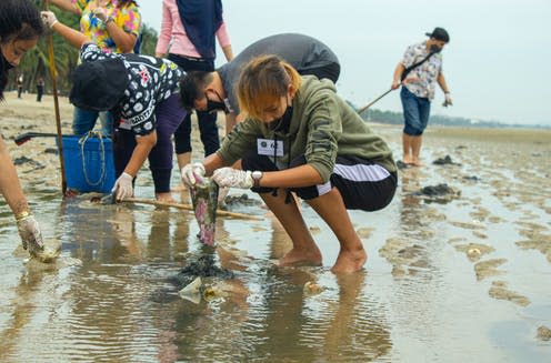 <span class="caption">Volunteers pay to help out on various projects from beach clearing to school building and animal conservation.</span> <span class="attribution"><a class="link " href="https://www.shutterstock.com/image-photo/chonburi-thailand-may-2020-group-volunteers-1740296063" rel="nofollow noopener" target="_blank" data-ylk="slk:Shutterstock;elm:context_link;itc:0;sec:content-canvas">Shutterstock</a></span>