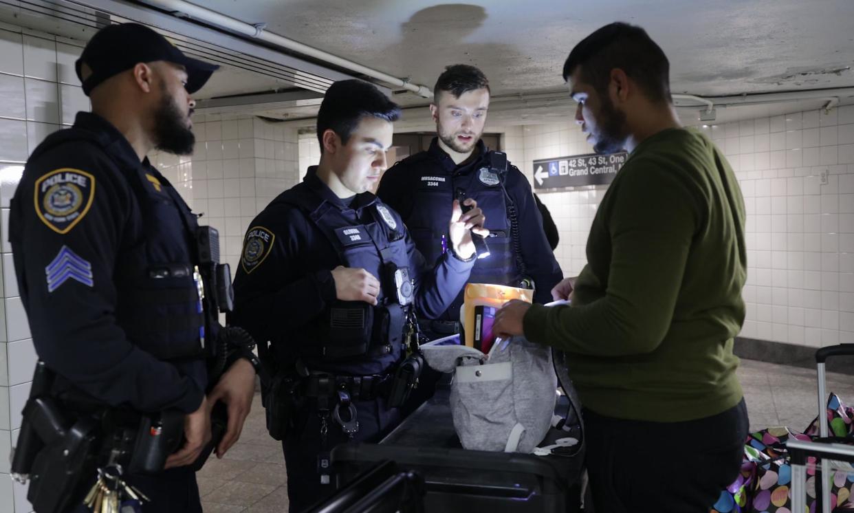 <span>Officers check bags on the subway in New York on Thursday.</span><span>Photograph: Anadolu/Getty Images</span>