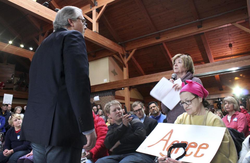 In this Feb. 23, 2017, file photo, Rep. David Young, R-Iowa, left, talks with Kay Marcel, of Urbandale, Iowa, during a town hall meeting in Urbandale, Iowa. A week of protests and raucous town halls isn't deterring President Donald Trump or the Republican congressional leadership. They're "staying the course" on health care, taxes and other issues. But the national pushback leaves some Republicans wary, not only about the next steps on the agenda but the possibility it could prove costly in next year's elections. (AP Photo/Linley Sanders)