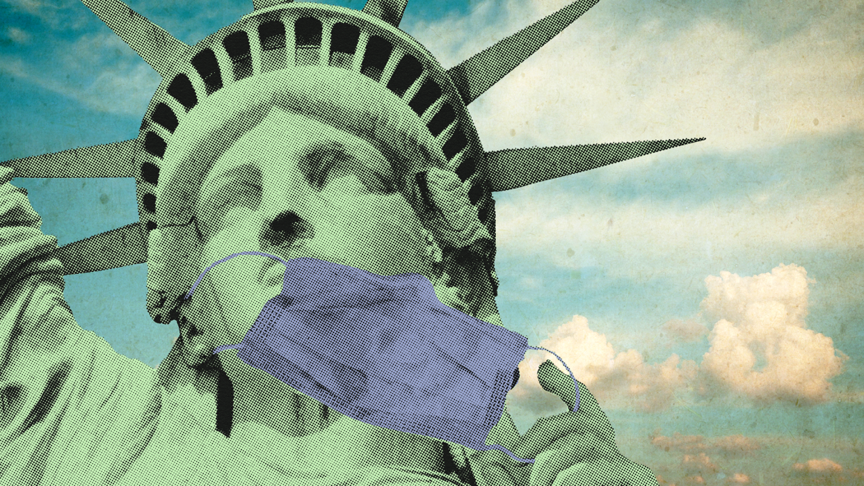 An image of the Statue of Liberty's face is embellish with a blue medical mask in hand next to her face