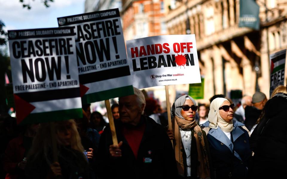 Pro-Palestinian demonstrators march to Downing Street to mark one year of the Israeli operations in the Gaza Strip and to call for a permanent ceasefire