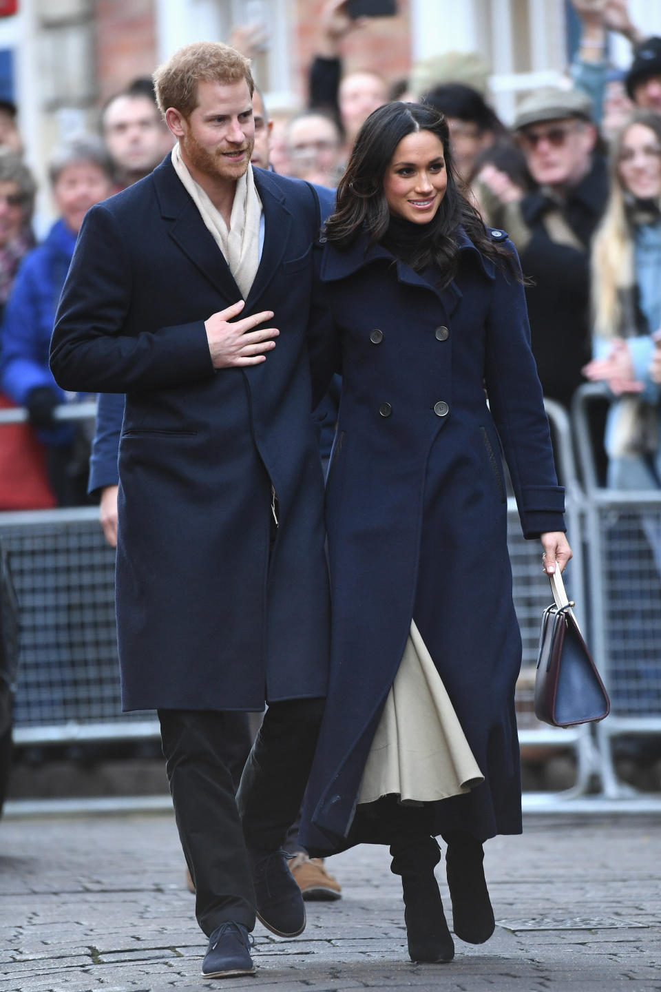 The couple dressed similarly in navy wool coats