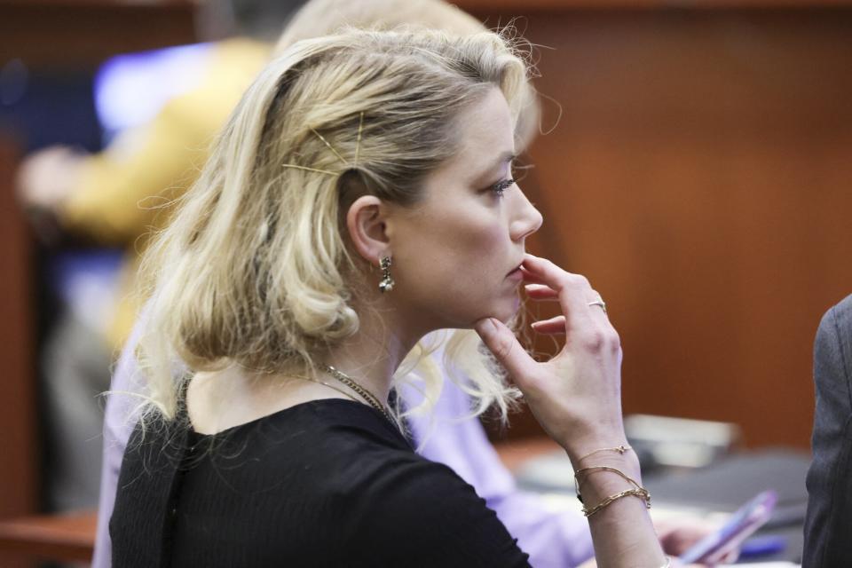 Amber Heard waits before the jury said that they believe she defamed ex-husband Johnny Depp, while announcing split verdicts in favor of both her ex-husband Johnny Depp and Heard