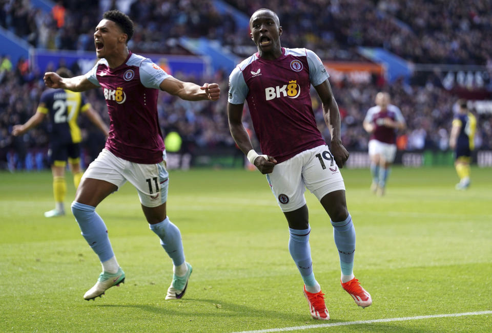 Aston Villa's Moussa Diaby, right, celebrates scoring their second goal of the game with teammate Ollie Watkins during the English Premier League soccer match between Bournemouth and Aston Villa at Villa Park stadium in Birmingham, England, Sunday April 21, 2024. (David Davies/PA via AP)