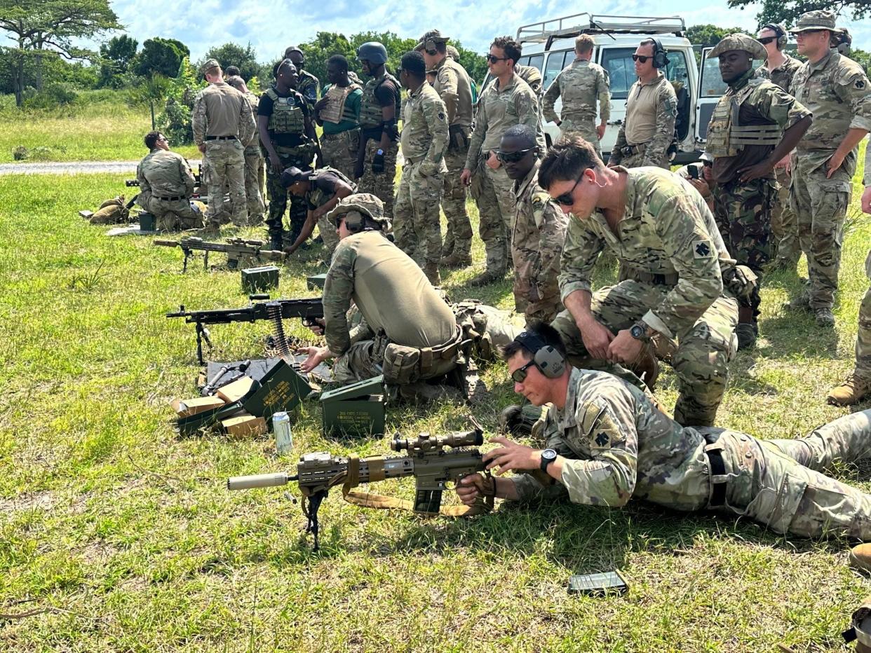 Indiana National Guard Specialist Zachery Archer trains Specialist Brock Hightower, both from Indianapolis, on a marksmen rifle at Camp Simba, Kenya, in 2023. Archer is his squad’s designated marksmen.