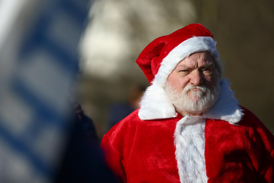 LONDON, ENGLAND - DECEMBER 05: A man dressed as Santa Claus attends a demonstration against the current Covid-19 restrictions in Hyde Park on December 5, 2020 in London, England. London has been in Tier 2 restrictions since the lockdown ended on December 2. (Photo by Hollie Adams/Getty Images)