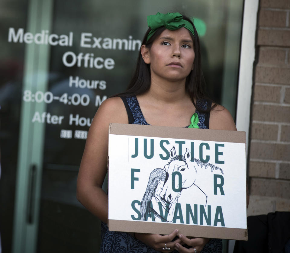 FILE - In this Aug. 29, 2017 file photo, Missy Jackson, 23, of Minneapolis, attends a prayer circle for Savanna LaFontaine-Greywind at the Ramsey County Medical Examiner's office in St. Paul, Minn. People wore green ribbons to honor Savanna, her favorite color. Interior Secretary Deb Haaland as a former New Mexico congresswoman pushed for a law signed last year to address the crisis of missing, murdered and trafficked Indigenous women. The law, known as Savanna’s Act, is intended to help law enforcement track, solve and prevent crimes against Native Americans, especially women and girls. The law is named for Savanna LaFontaine-Greywind, a member of the Spirit Lake tribe who was abducted and killed in 2017 near Fargo, North Dakota. (Leila Navidi/Star Tribune via AP, File)