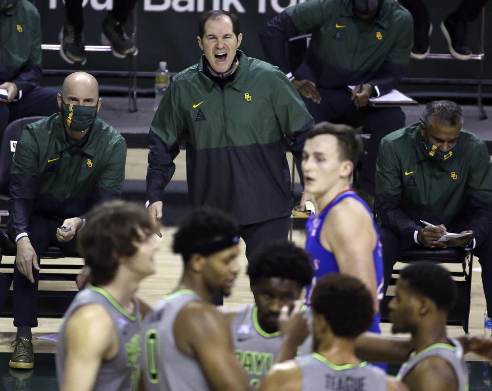 File-Baylor head coach Scott Drew, top center, reacts to a play in the second half of an NCAA college basketball game against Kansas, Monday, Jan. 18, 2021, in Waco, Texas. “You get to spend the entire year helping your game get better without the outside pressure or having to worry about being ready for each and every game, so it’s truly one year of development,” Drew said of redshirts, for current players and Bears in the past decade who went on to play professionally. (AP Photo/Jerry Larson, File)