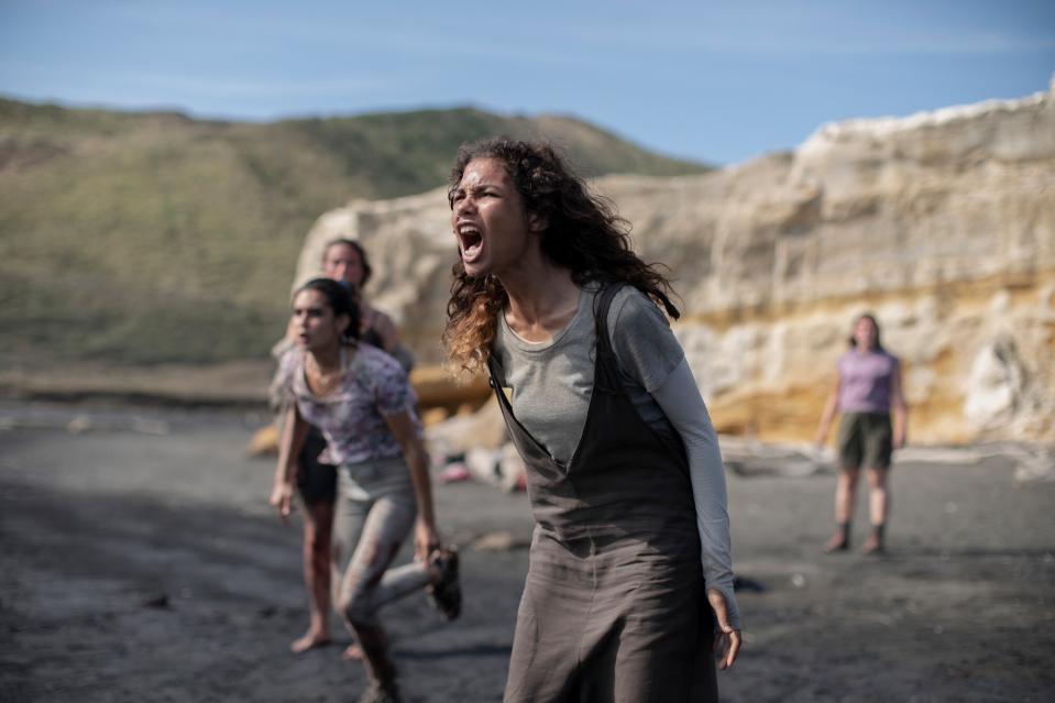 A group of girls scream for help on a beach