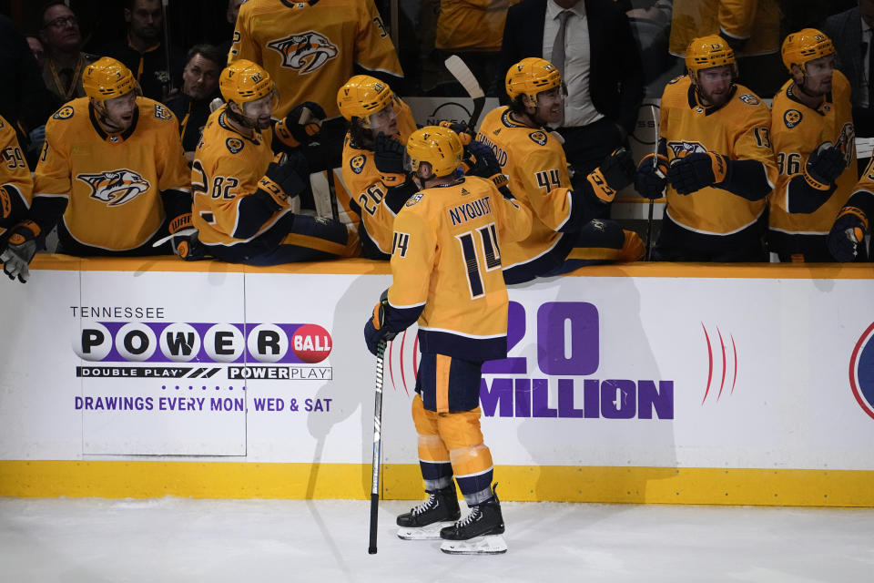 Nashville Predators teammates congratulate left wing Gustav Nyquist (14) after his goal against the Seattle Kraken during the third period of an NHL hockey game Thursday, Oct. 12, 2023, in Nashville, Tenn. The Predators won 3-0. (AP Photo/George Walker IV)