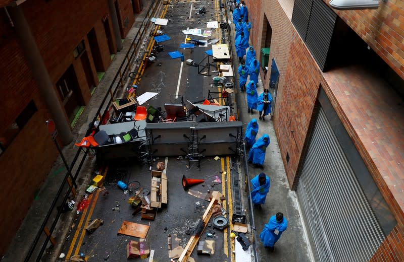 Protesters leave the Hong Kong Polytechnic University campus to surrender to police, in Hong Kong