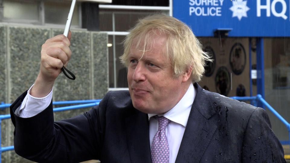 Boris Johnson braved the weather to visit Surrey Police headquarters (PA)