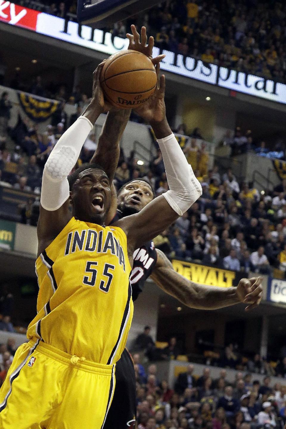 Indiana Pacers center Roy Hibbert (55) shoots in front of Miami Heat forward Udonis Haslem during the second half of an NBA basketball game in Indianapolis, Wednesday, March 26, 2014. The Pacers won 84-83. (AP Photo/AJ Mast)