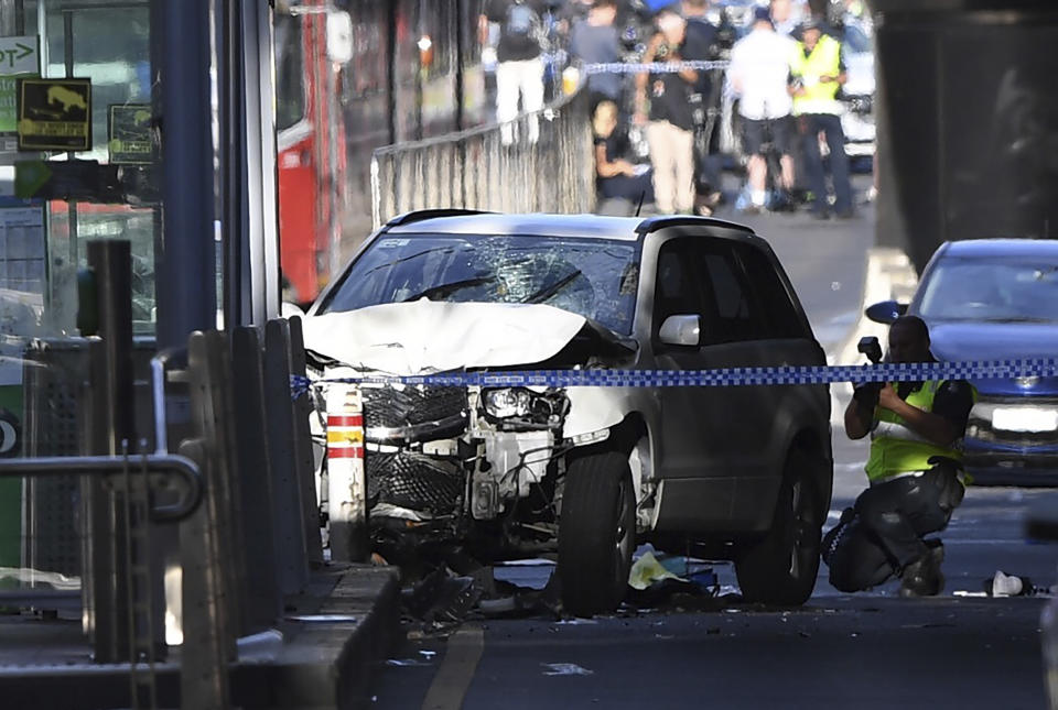 <em>‘Mayhem’ – a damaged vehicle is seen at the scene of the attack on Flinders Street, Melbourne (Pictures: AP)</em>