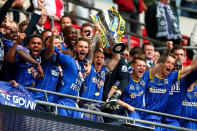<p>Barry Fuller of Wimbledon lifts the trophy with his teammates after they win the Sky Bet League Two playoff final match between Plymouth Argyle and AFC Wimbledon at Wembley Stadium on May 30, 2016, in London. (Jordan Mansfield/Getty Images) </p>