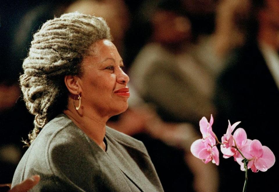 In this April 5, 1994 file photo, Toni Morrison as she holds an orchid at the Cathedral of St. John the Divine in New York.  The Nobel Prize-winning author has died. Publisher Alfred A. Knopf says Morrison died Monday, Aug. 5, 2019 at Montefiore Medical Center in New York. She was 88.