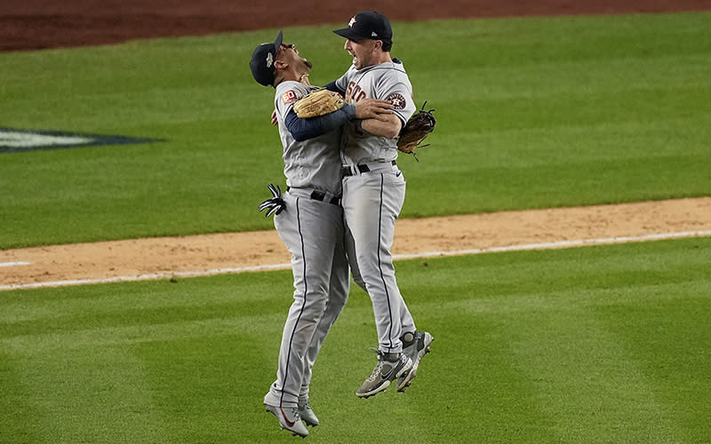 Houston Astros players celebrate after the Astros defeated the New York Yankees