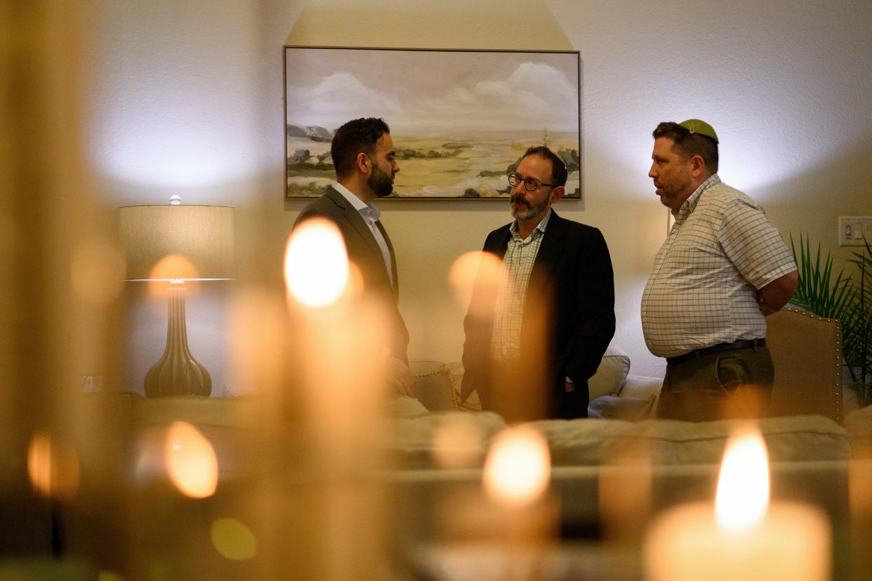 Shariq Ghani, who is Muslim, Oren Hayon, a rabbi at Congregation Emanu El, and Gideon Estes, a rabbi at Congregation Or Ami, have a conversation as friends of different faiths gather for iftar at Ghani’s home in Richmond, Texas, on April 2, 2024.