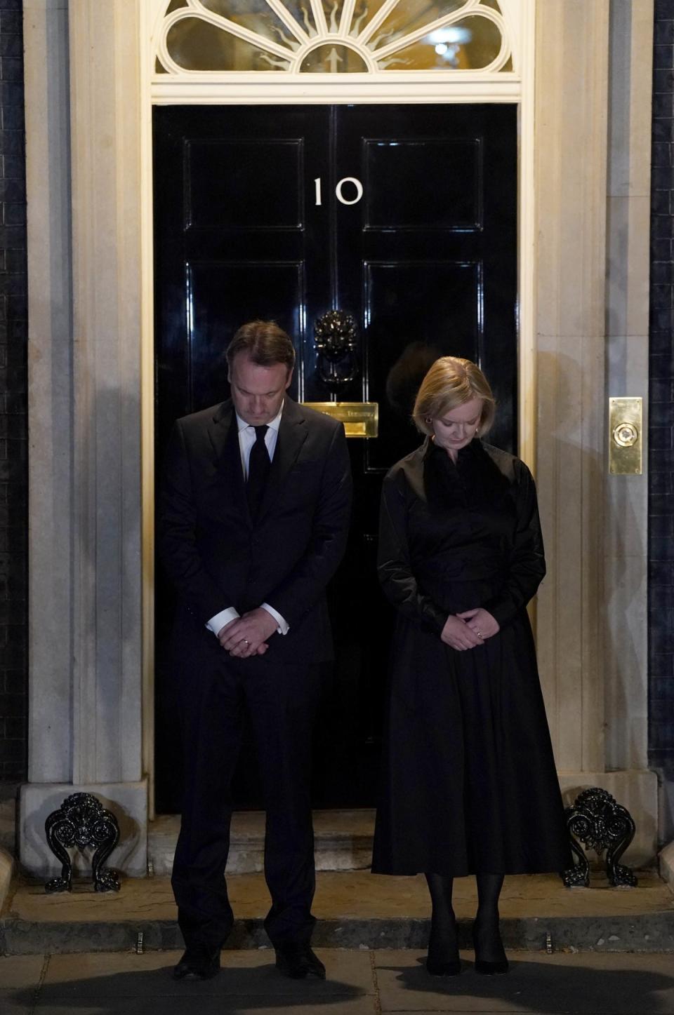 Prime Minister Liz Truss and her husband Hugh O’Leary observe the national minute’s silence (Jacob King/PA) (PA Wire)