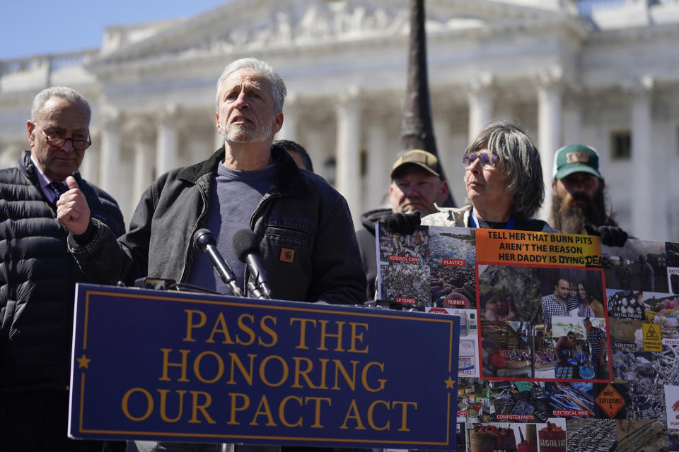 FILE - Activist and entertainer Jon Stewart speaks at a press conference on the PACT Act to benefit burn pit victims on Capitol Hill, Tuesday, March 29, 2022, in Washington. Hundreds of thousands of veterans have received additional benefits in the past year after President Joe Biden signed legislation expanding coverage for conditions connected to burn pits that were used to destroy trash and potentially toxic materials. (AP Photo/Mariam Zuhaib, File)