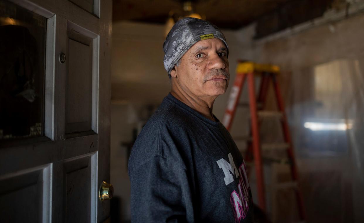 Rafael Sanchez, 68, stands inside his home in Detroit on Tuesday, Oct. 24, 2023. Sanchez filed for Pandemic Unemployment Assistance benefits in 2021 after work was only trickling in at the automotive repair business he owned. Years later, he's still waiting on those benefits even though a judge determined in July he's eligible for benefits.
