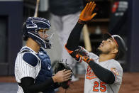 Baltimore Orioles' Anthony Santander looks up as he scores next to New York Yankees catcher Gary Sanchez on a fourth-inning, solo home run off Yankees pitcher Jameson Taillon in a baseball game Wednesday, April 7, 2021, at Yankee Stadium in New York. (AP Photo/Kathy Willens)