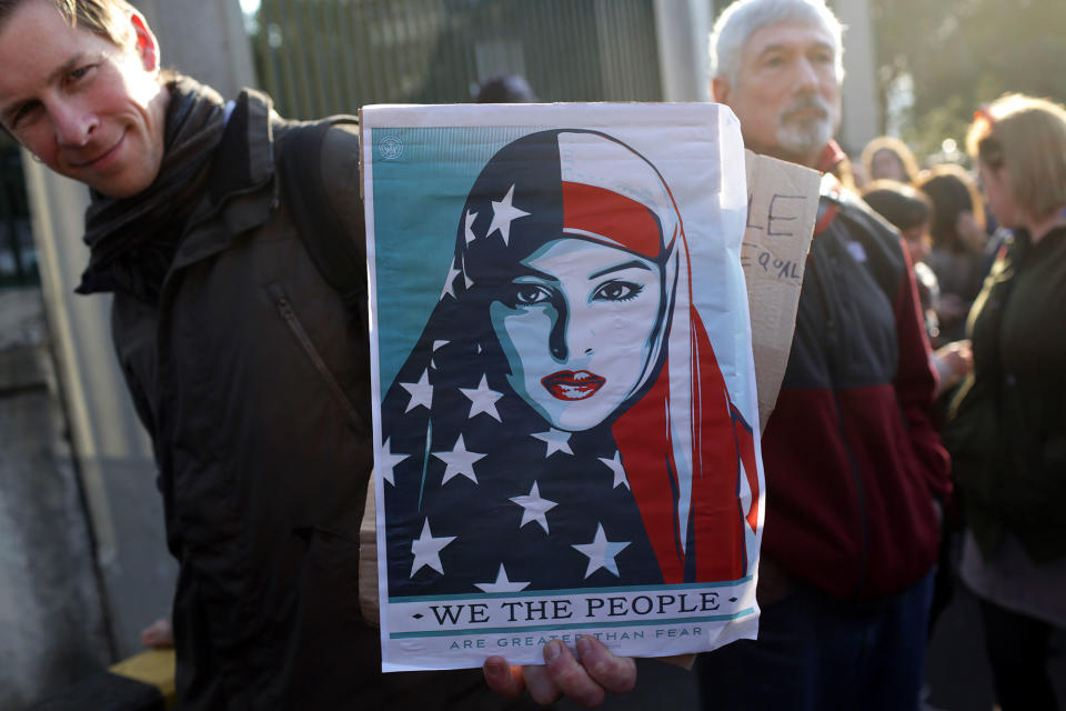 <p>A demonstrator holds a poster outside the U.S. embassy, in the background, during a Women’s March Saturday, Jan. 21, 2017, in Lisbon. The march is part of a worldwide day of actions following the inauguration of U.S. President Donald Trump. (AP Photo/Armando Franca) </p>