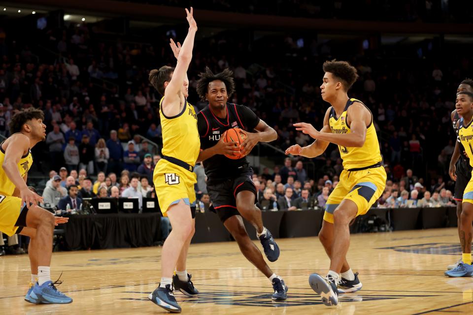 Connecticut guard Tristen Newton (2) drives to the basket against Marquette guard Tyler Kolek (11) and forward Oso Ighodaro (13) during their 2023 Big East tournament game at Madison Square Garden.