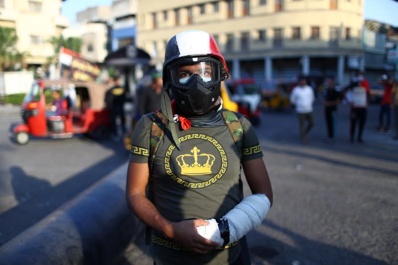 Hamza, an Iraqi demonstrator, poses for a photograph during the ongoing anti-government protests in Baghdad