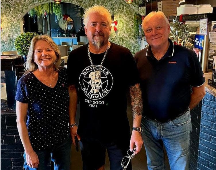 Food Network star, Guy Fieri, poses with customers at Venezia Pizza & Ristorante in North Palm Beach.