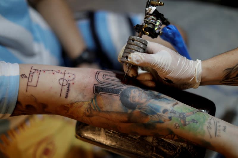 The Wider Image: Argentines celebrate 'eternal love' for Maradona with tattoos