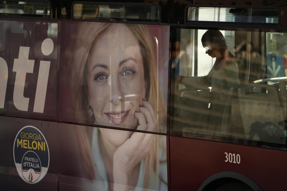 A poster of Italy's candidate premier Giorgia Meloni stands on the side of a bus in Rome, Friday, Sept. 16, 2022. Italy could be on the verge of electing its first woman premier. That prospect delights some Italian women, but others are dismayed by her conservative beliefs and policies. If opinion polls prove on the mark, Giorgia Meloni and the far-right Brothers of Italy party she co-founded less than a decade ago will triumph in Sept. 25 elections for Parliament. (AP Photo/Alessandra Tarantino)