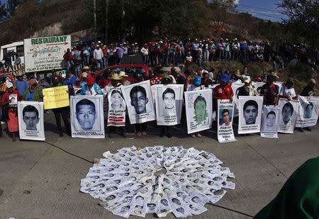 Parents of the missing students from Ayotzinapa Teacher Training College Raul Isidro Burgos march during a demonstration marking the third anniversary of the death of two students who died during clashes with the police while protesting for more jobs after graduation, and also to demand justice for the 43 trainee teachers who were abducted by corrupt police 10 weeks ago in Chilpancingo, Guerrero December 12, 2014. REUTERS/Jorge Dan Lopez