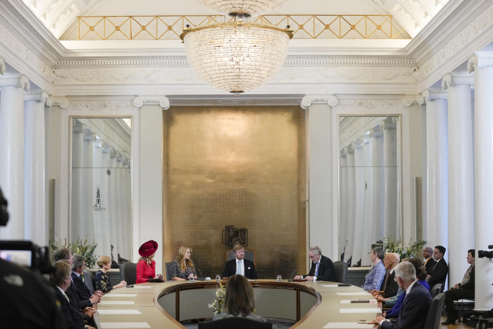 Heir to the Dutch throne Princess Amalia, center rear left, speeches as she takes an honorary seat at the Council of State, the highest government advisory body, while her mother Queen Maxima, left in red, and father King Willem-Alexander, rear center, listen, in The Hague, Netherlands, Wednesday, Dec. 8, 2021, one day after celebrating her eighteenth birthday. (AP Photo/Peter Dejong, Pool)