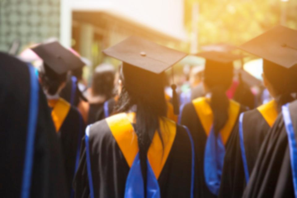 Group of Graduates during commencement. Concept education congratulation in University. Graduation Ceremony in University during commencement. close up hat.