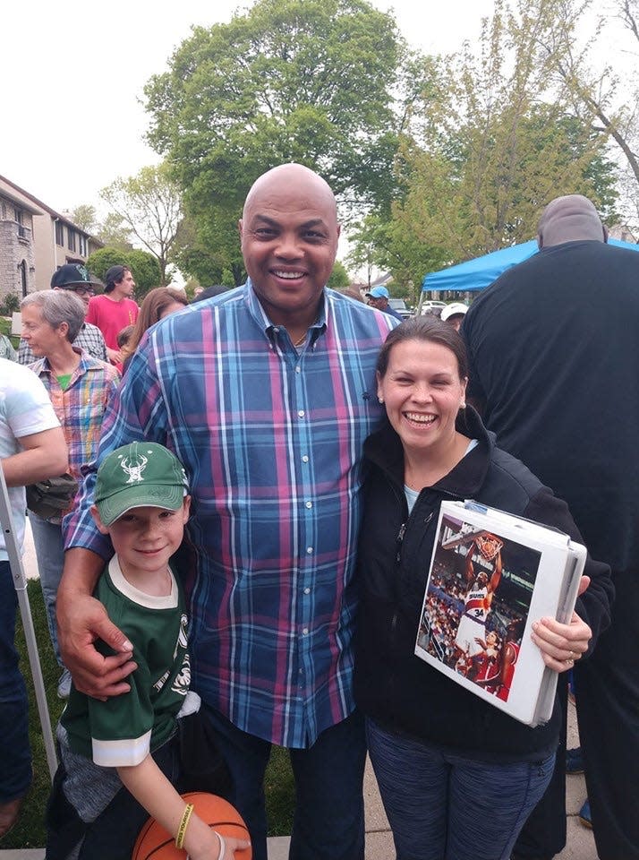 Charles Barkley poses with Liam Wills and his mom Jen Wills (holding a binder) on May 16 at a block party in the Enderis Park neighborhood in Milwaukee.