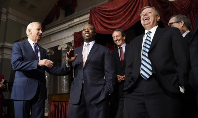FILE - Vice President Joe Biden laughs with Sen. Lindsey Graham, R-S.C., second from right, following a ceremonial swearing-in ceremony for Sen. Tim Scott, D-S.C., second from left, in the Old Senate Chamber on Capitol Hill in Washington, Dec. 2, 2014. Rep. Mark Sanford, R-S.C., is center. Scott has filed paperwork to enter the 2024 Republican presidential race. He'll be testing whether a more optimistic vision of America’s future can resonate with GOP voters who have elevated partisan brawlers in recent years. (AP Photo/Susan Walsh, File)