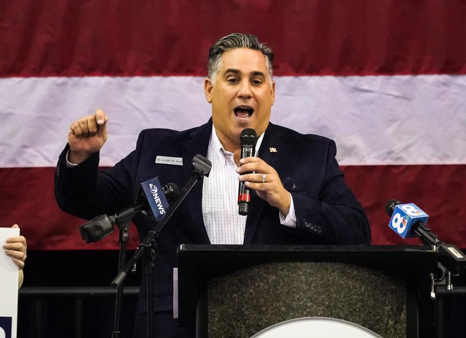 Joe Neunder speaks at a Republican rally at Robarts Arena in Sarasota this summer.