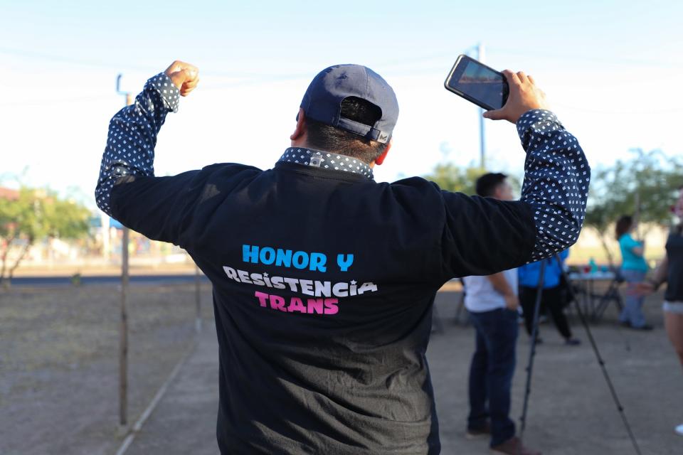 Daybeth Ruiz P. shows off a trans rights shirt at a Trans Queer Pueblo general meeting in Phoenix on June 13, 2023.