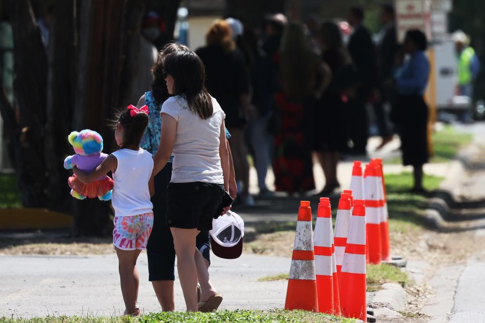 People arrive to watch President Joe Biden arrive for mass at Sacred Heart Catholic Church on May 29, 2022 in Uvalde, Texas.